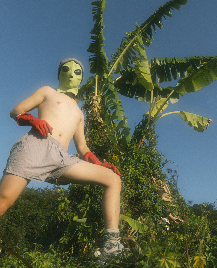 Yiyi wearing an alien mask outdoors